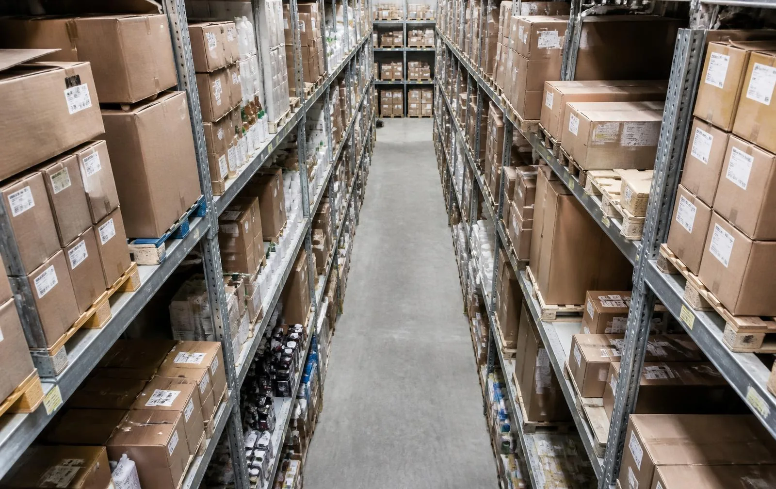 Organised warehouse shelving holding cartons and inventory